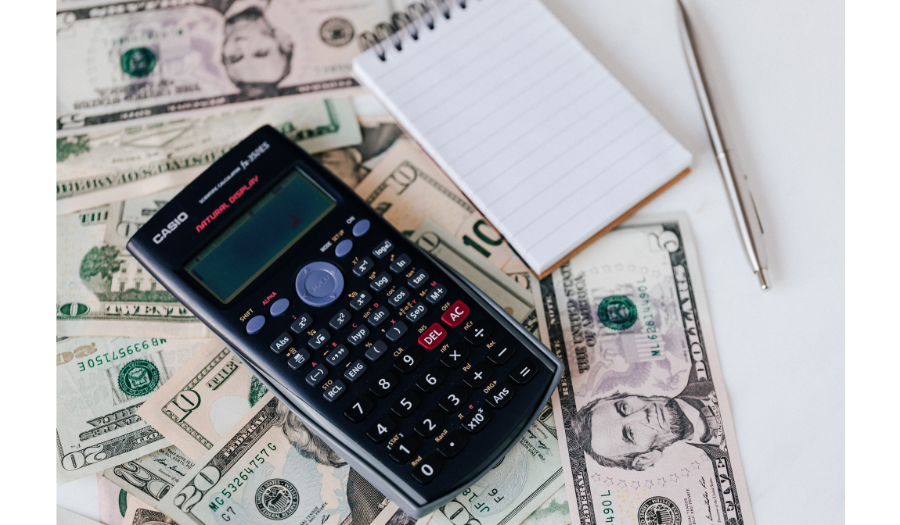 Calculator with money, notepad, and pen