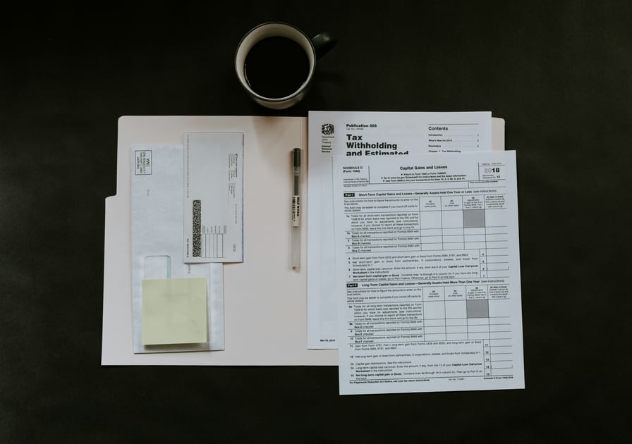 IRS tax forms on a desk with a mug of coffee